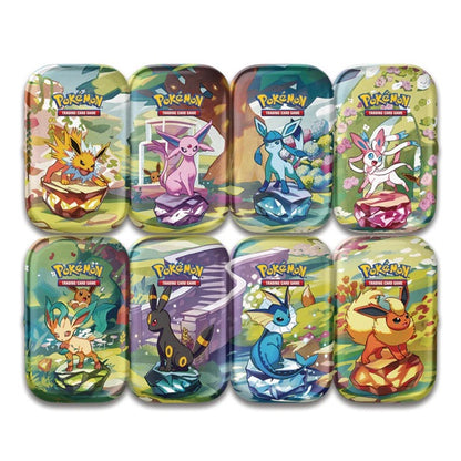 Set of eight colorful Pokémon trading card game tins on a white background